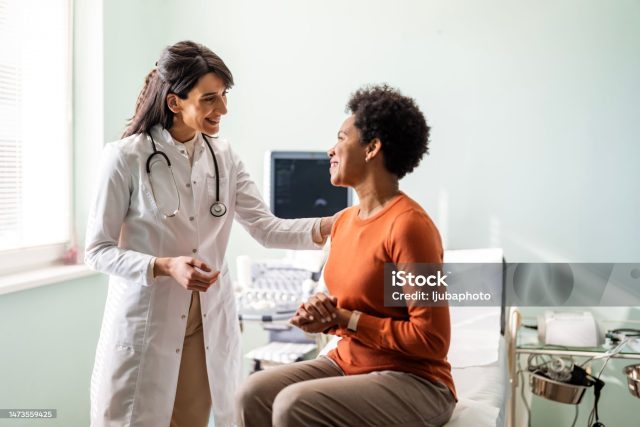 Female medical practitioner reassuring a patient